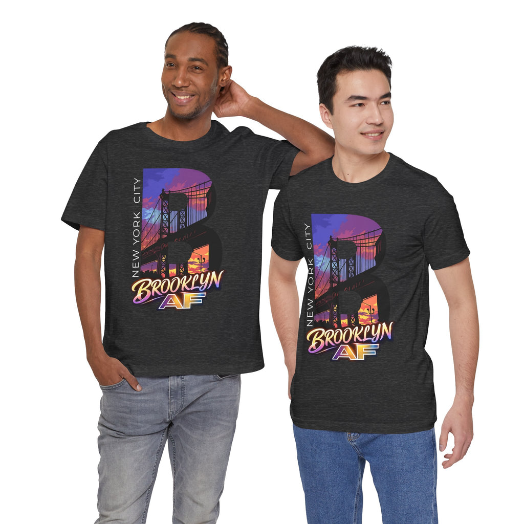 Two models wearing dark grey heather t-shirts, front view, both featuring the 'B' Brooklyn Bridge sunset skyline graphic