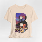 Vintage White tee, flat lay, front view, featuring the oversized "B" Brooklyn Bridge sunset skyline graphic.