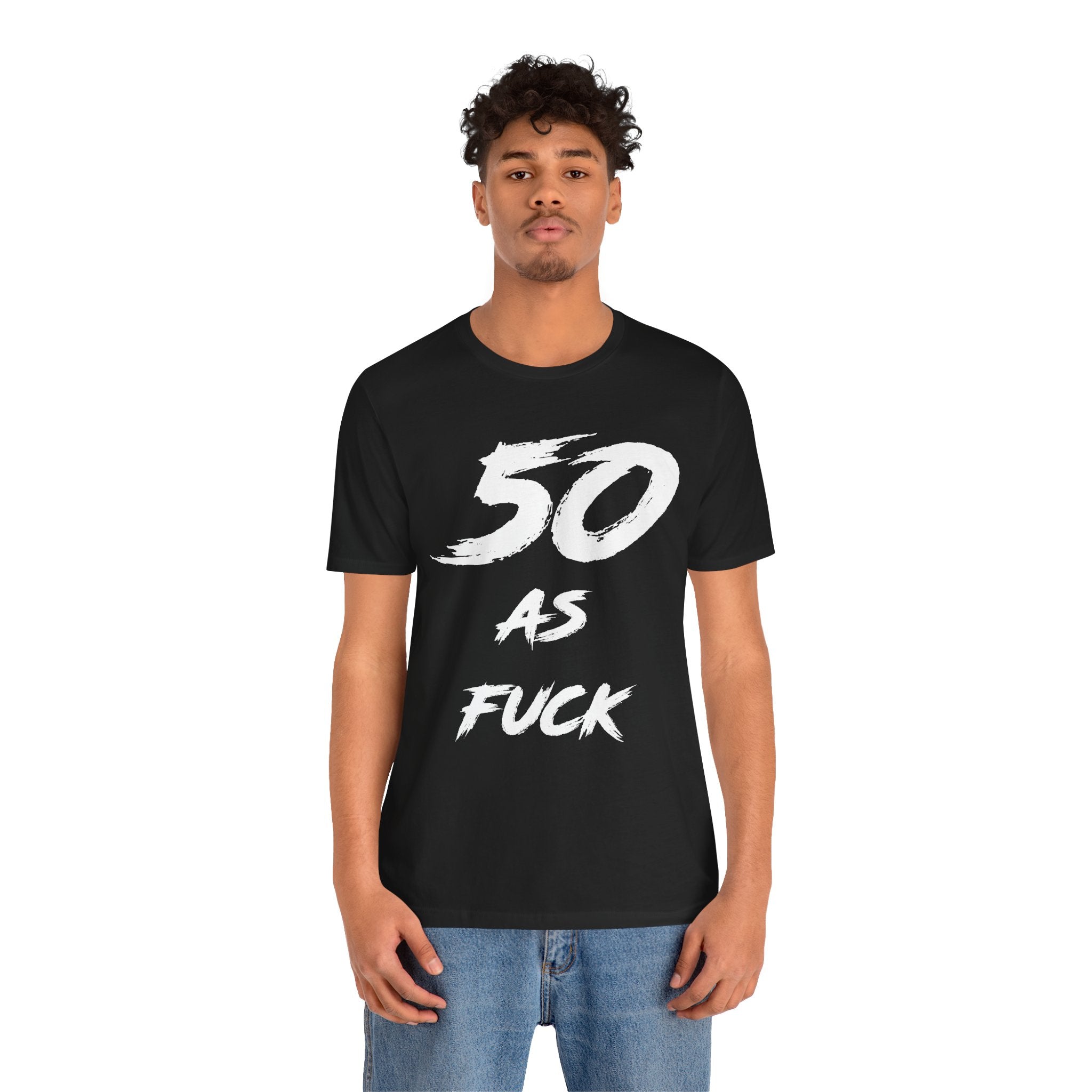 Man wearing the black 50 AS FUCK birthday t-shirt with jeans, front view