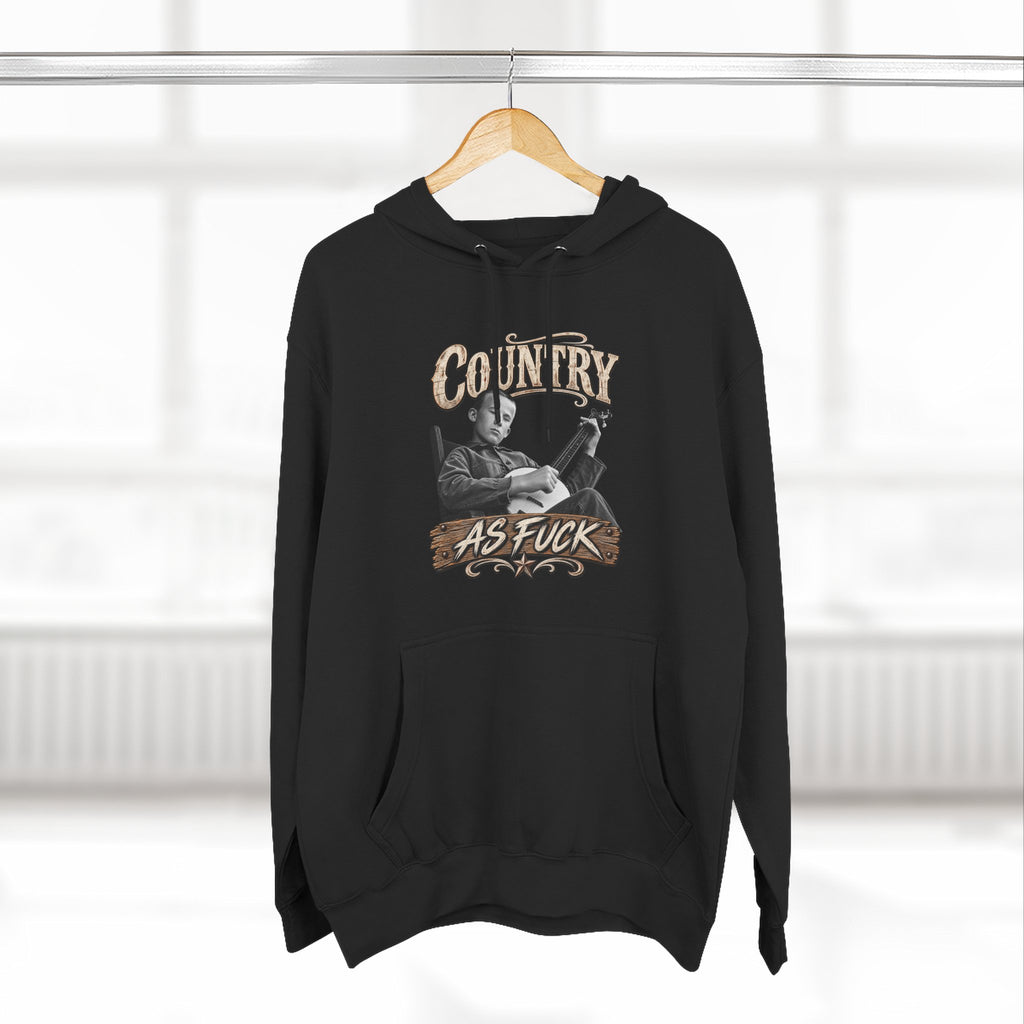 Black Country As Fuck hoodie on a wooden hanger by a window
