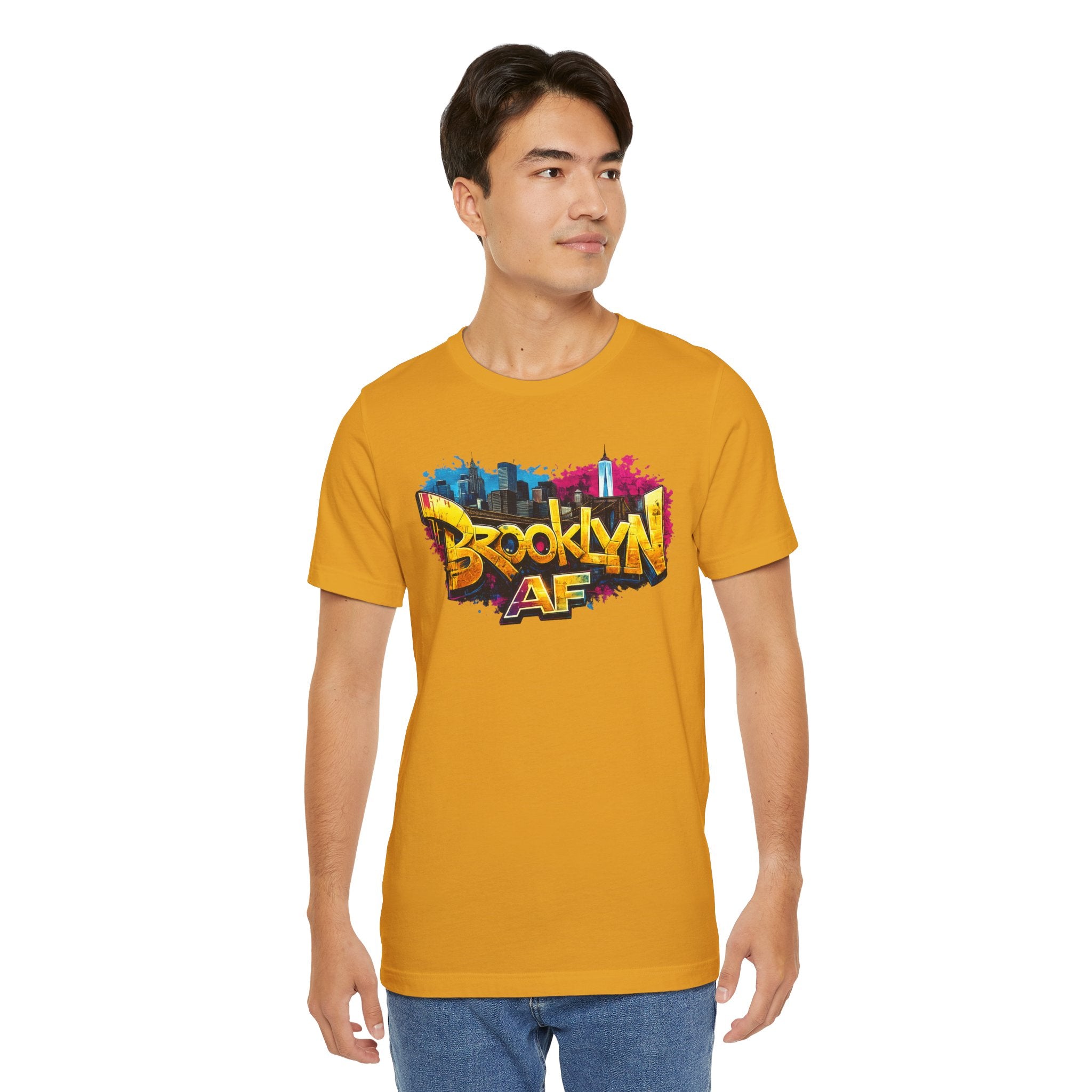 Mustard yellow t-shirt worn by a male model, front view, with graffiti-style Brooklyn AF lettering over a skyline.