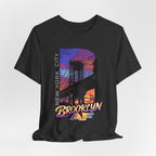 Dark grey heather t-shirt, flat lay front view, with a bold B and a purple-orange Brooklyn Bridge sunset skyline graphic.