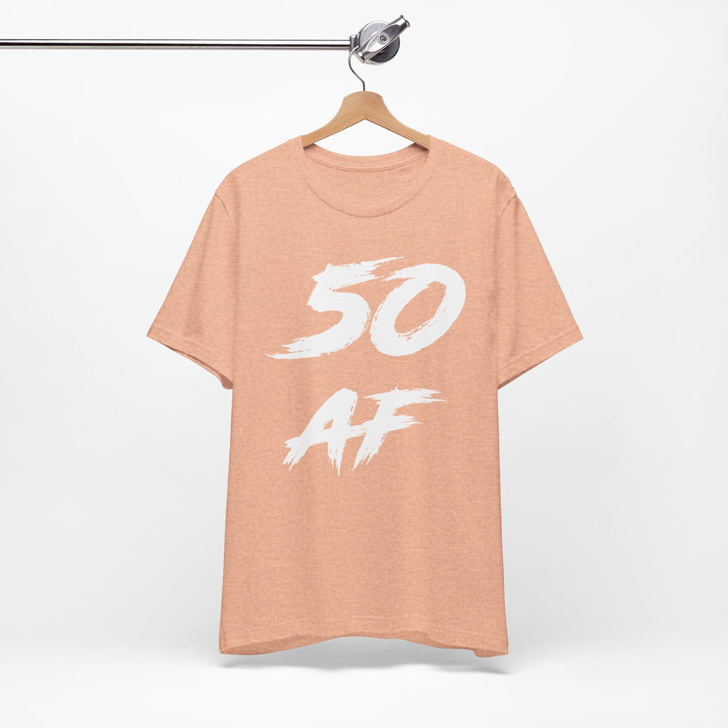 Heather Peach 50 AF birthday tee on a wooden hanger showing the white front print