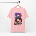 Pink tee on a hanger, front view, showing the oversized "B" Brooklyn Bridge sunset skyline graphic and logo.
