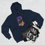 Navy hoodie flat lay styled with jeans, white belt, and sneakers, showing the oversized "B" Brooklyn Bridge skyline graphic.