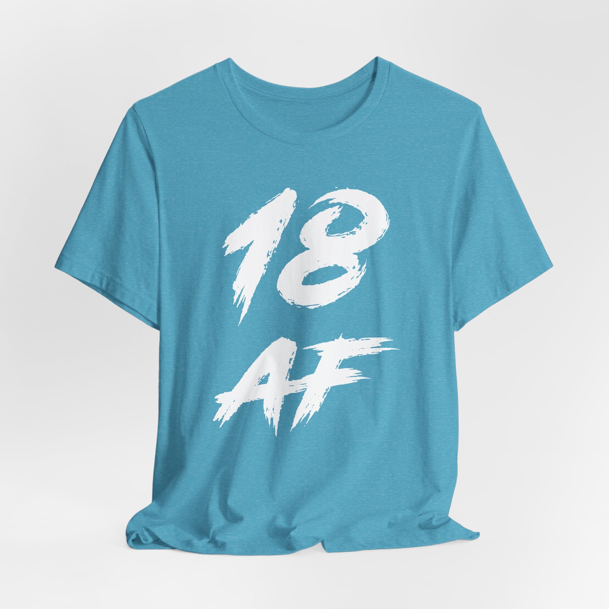 Heather Aqua tee laid flat and slightly rumpled, white 18 AF brush graphic