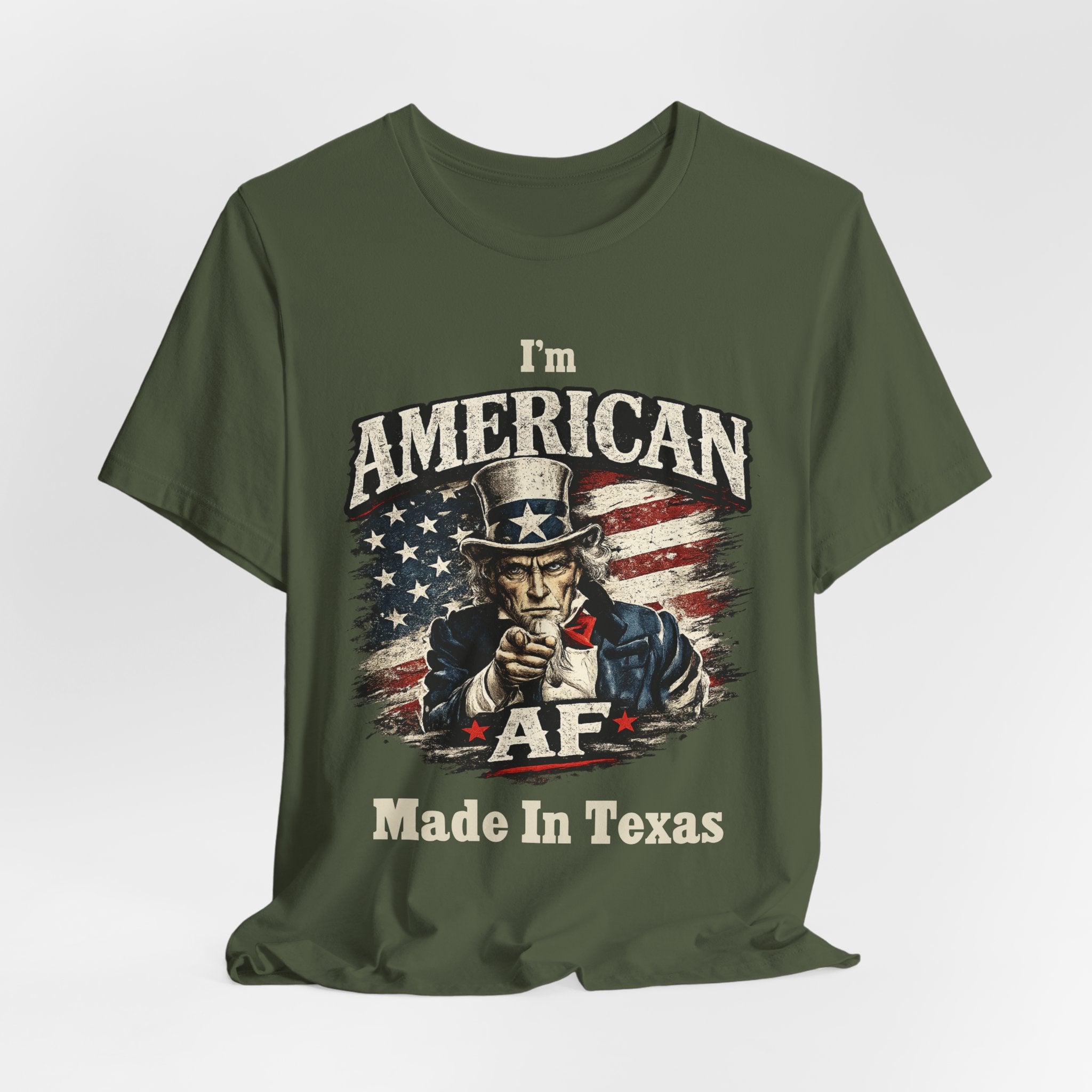 Olive green t-shirt casually draped, showing the Uncle Sam graphic and AF Made In Texas text.