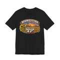 Black Kansas AF tee laid flat, sunflowers and wheat framing the prairie sunset badge