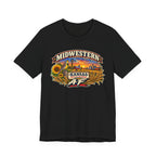 Black Kansas AF tee laid flat, sunflowers and wheat framing the prairie sunset badge