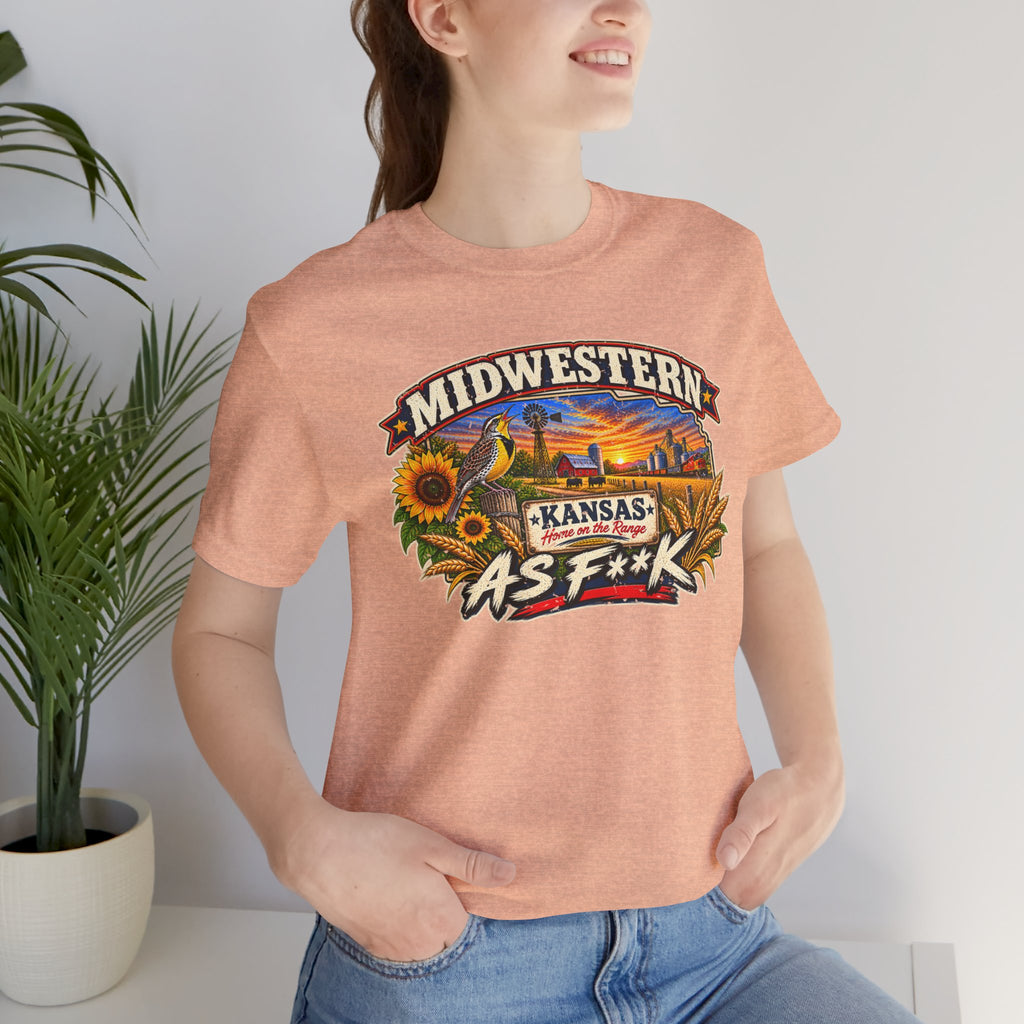 Woman in the heather peach Kansas As F**K tee indoors beside a potted plant