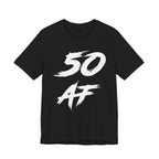 Black birthday tee laid flat, white distressed 50 AF lettering across the chest