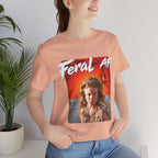 Woman wearing the Heather Peach Feral AF T-shirt indoors, the red desert graphic on her chest