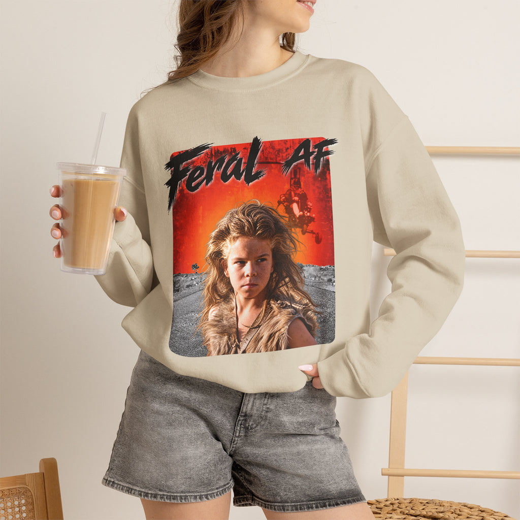 Woman wearing the Sand Feral AF crewneck with denim shorts and an iced coffee in hand