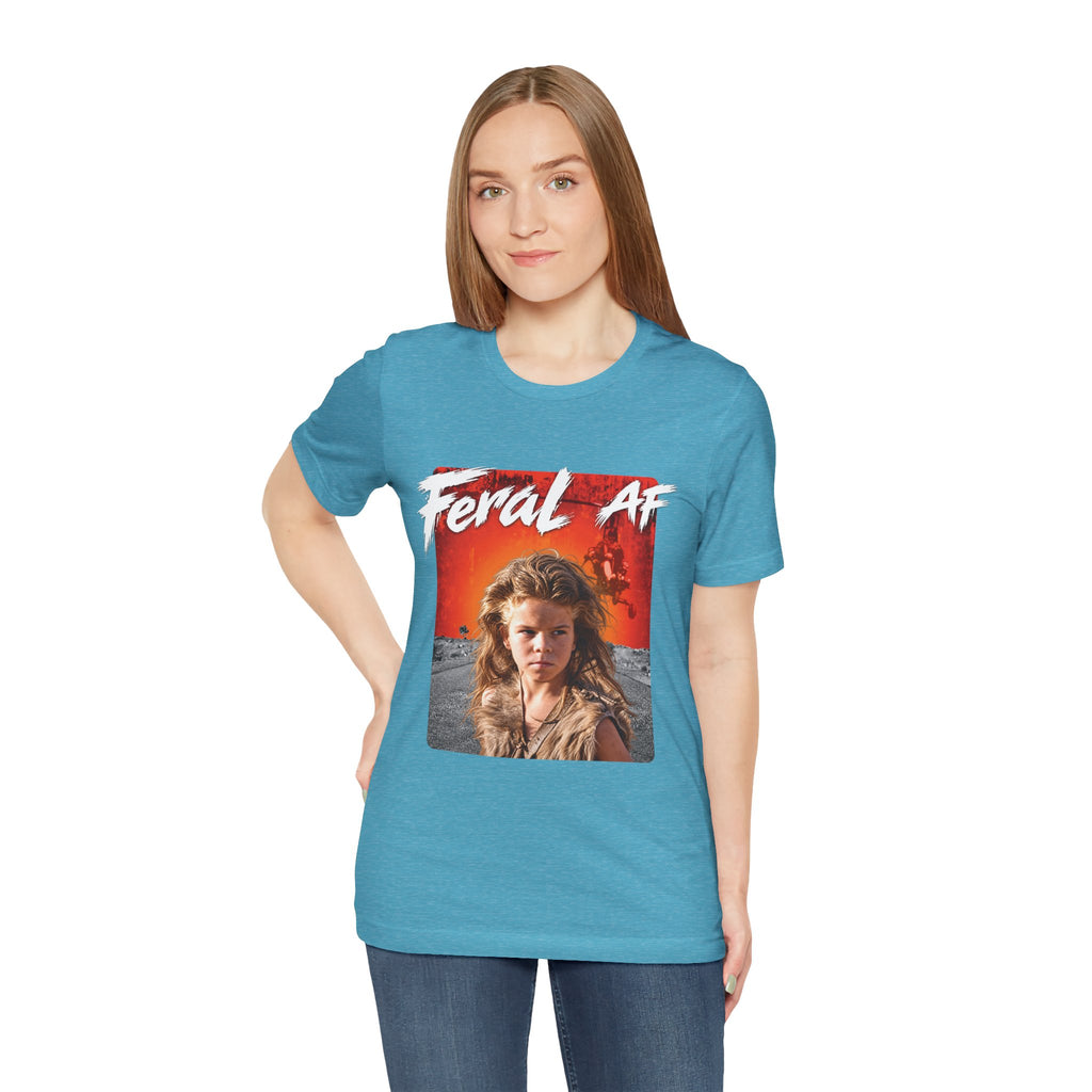 Woman wearing the Heather Aqua Feral AF tee, the orange front print bright against the aqua fabric