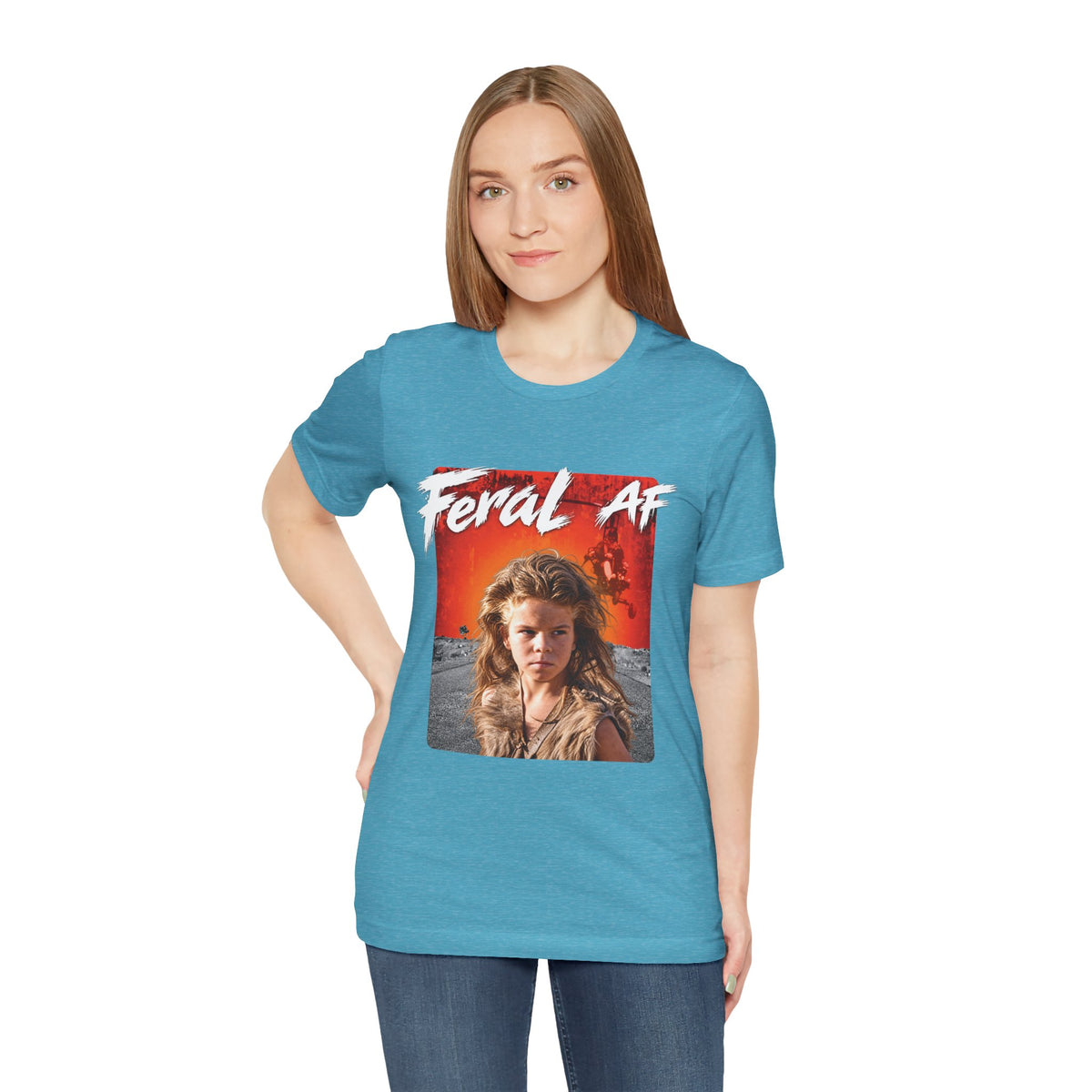 Woman wearing the Heather Aqua Feral AF tee, the orange front print bright against the aqua fabric