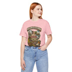Woman wearing pink Ohio Midwestern As Fuck t-shirt with Buckeye State graphic, hand in pocket