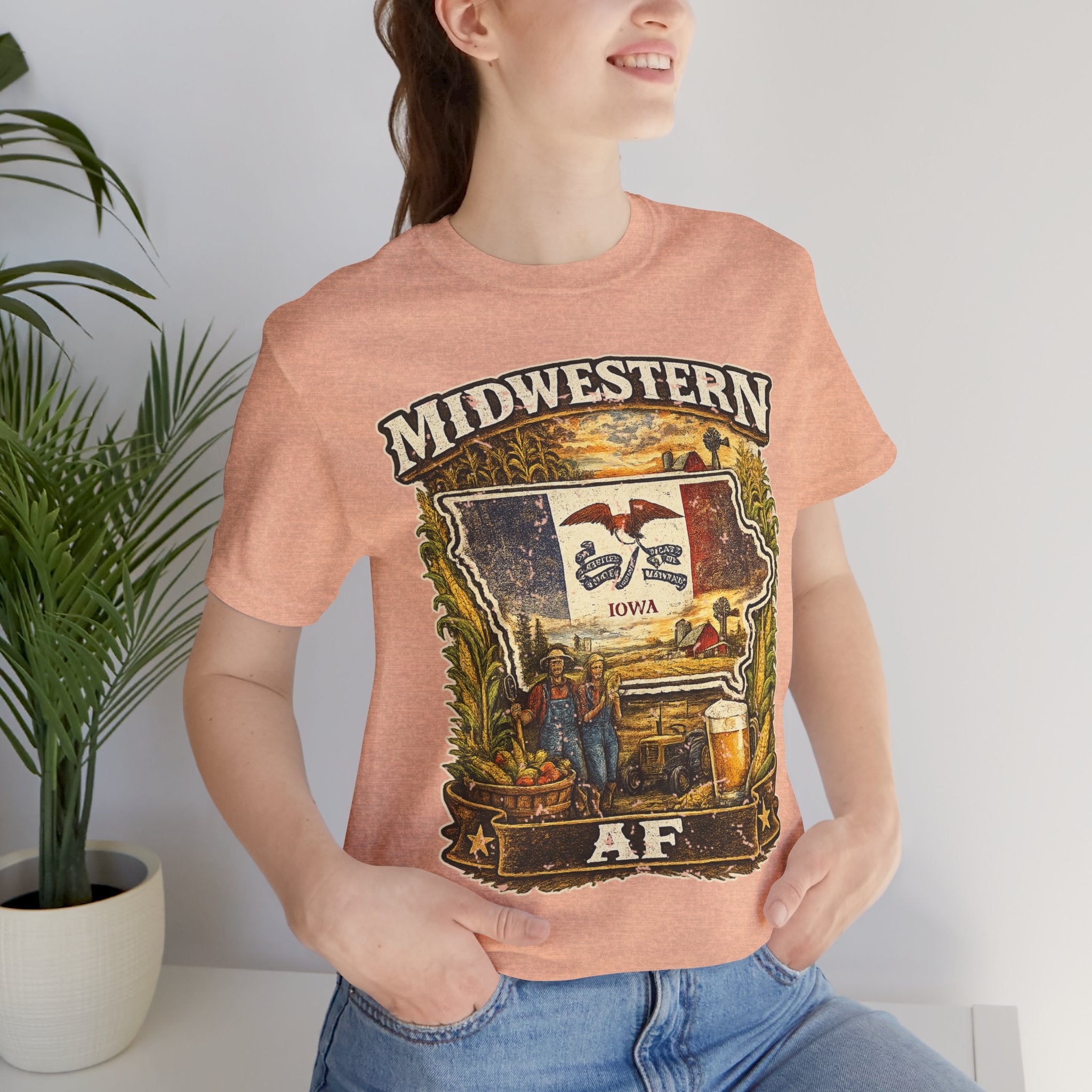 Family Friendly Midwestern AF Iowa T-Shirt – product photo 8 featuring a distressed vintage design featuring the outline of Iowa overlaid with the Iowa state flag, surrounded by towering corn stalks, rolling farmland, a classic red barn, a windmill, a tractor, and an overflowing harvest basket