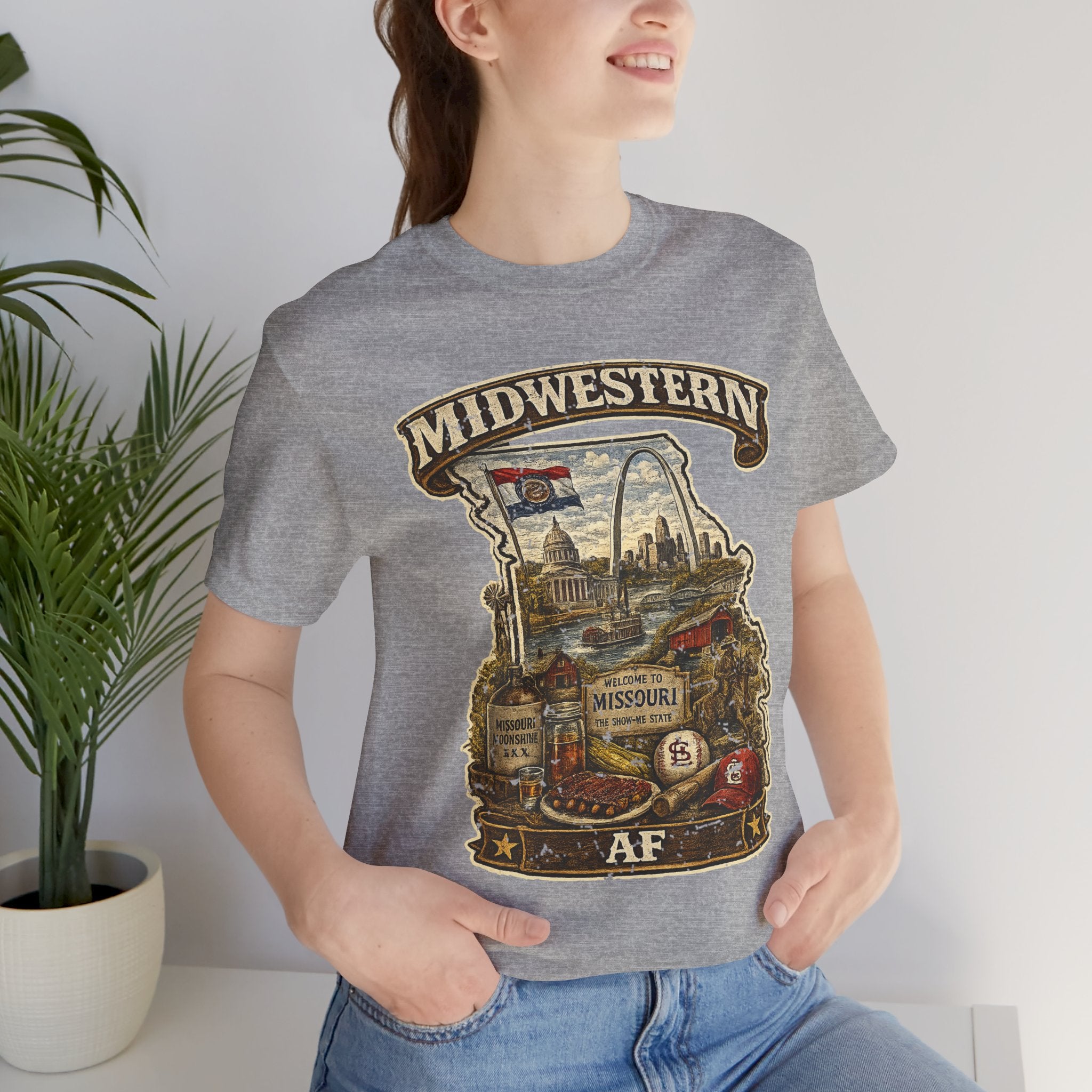 Close-up of woman wearing athletic heather grey Missouri Midwestern AF t-shirt, vintage Show-Me State graphic with Gateway Arch