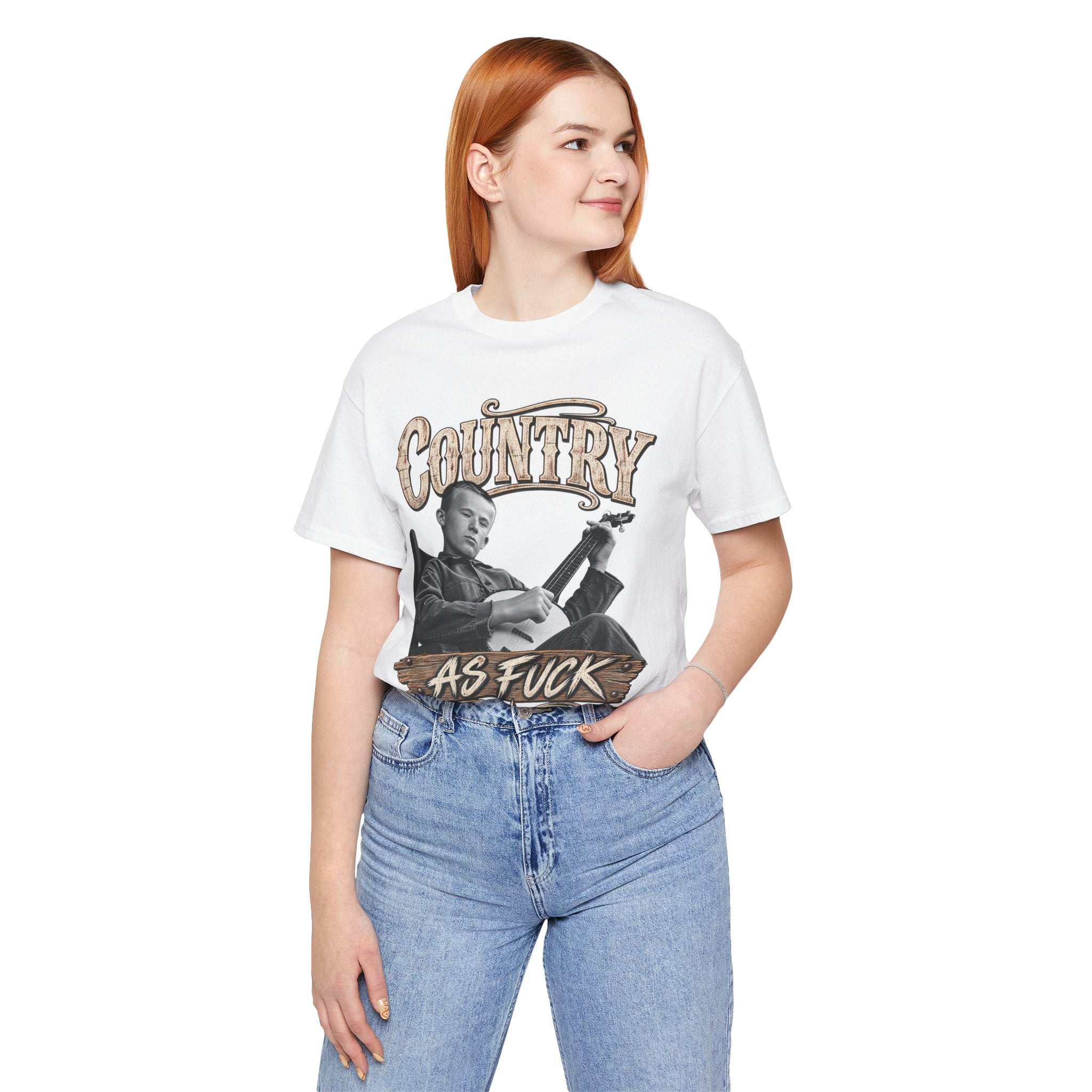 Red-haired woman in the White Country As Fuck tee with blue jeans