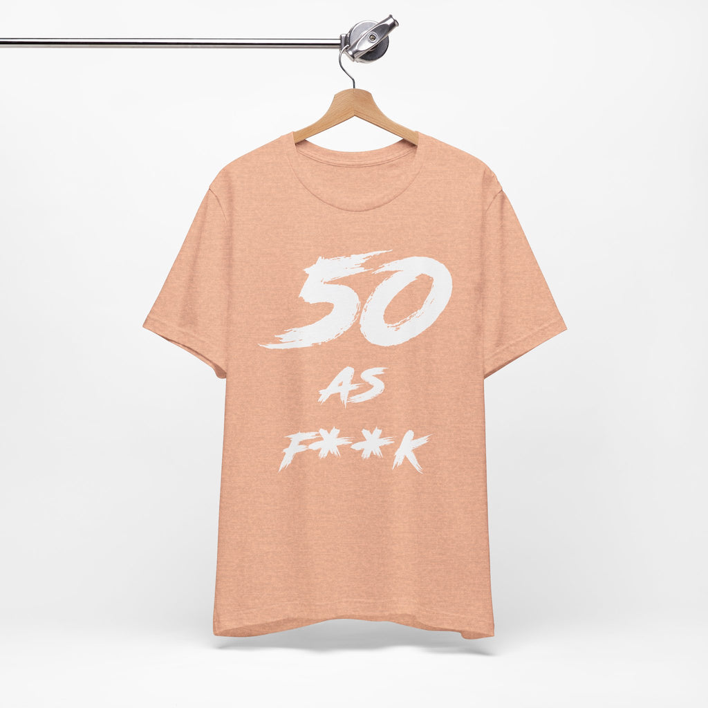 Heather Peach birthday t-shirt on a wooden hanger showing the white 50 AS F**K print