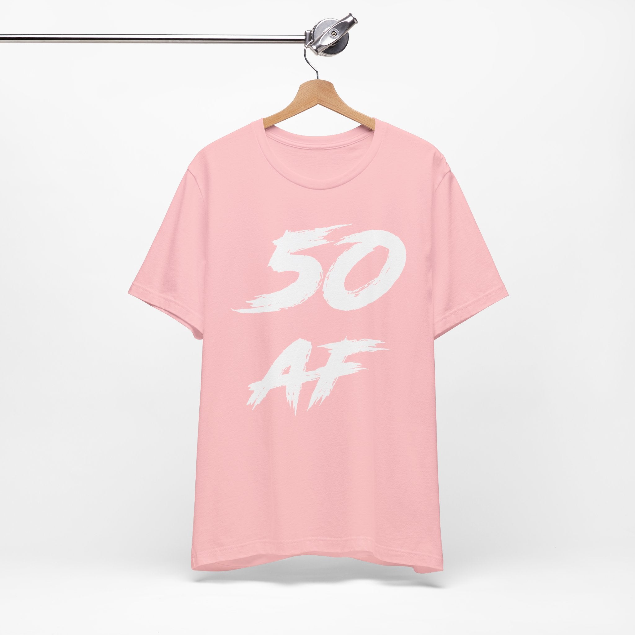 Pink birthday t-shirt on a hanger with the white 50 AF brush print