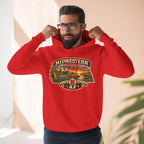 Bearded man in the red Nebraska hoodie against a warm stucco wall