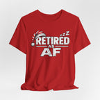 Red Retired AF T-shirt draped over a soft surface showing the front print