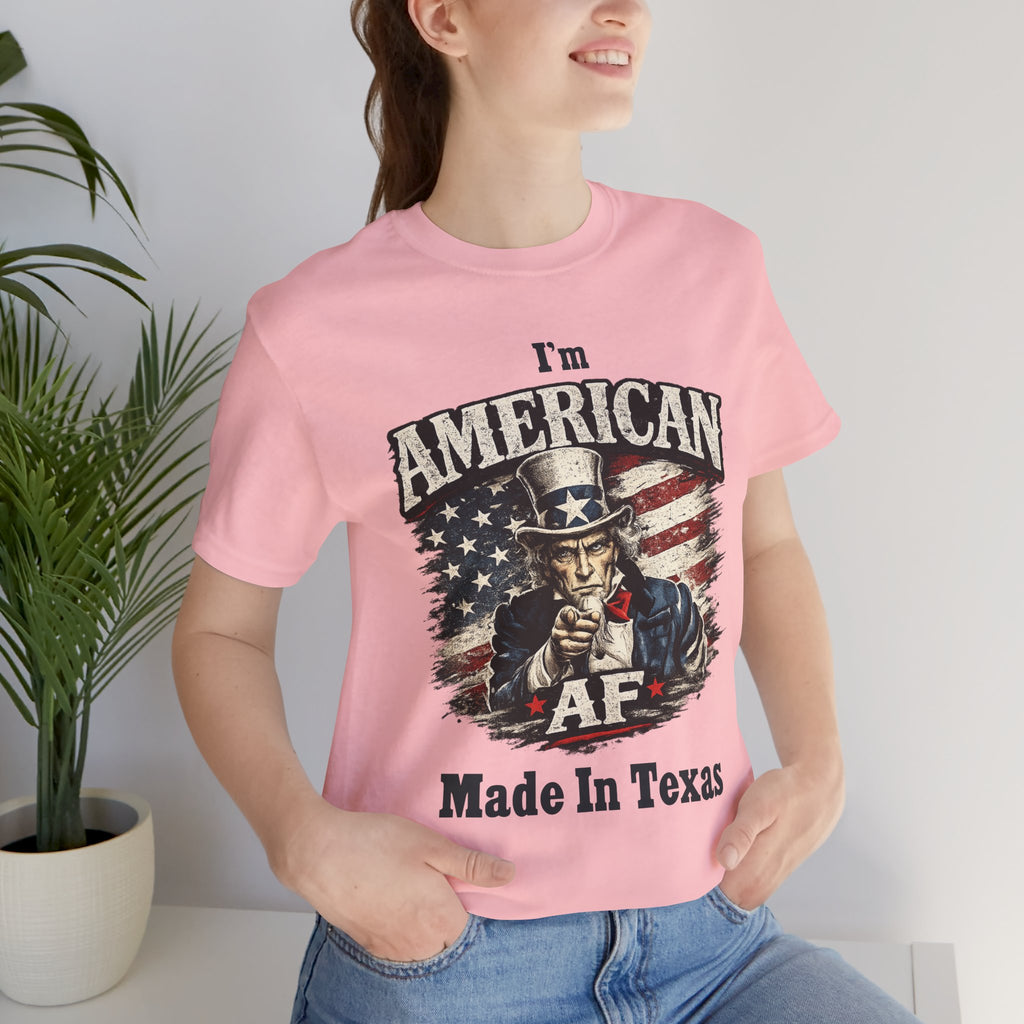Close-up of a female model in a pink tee with the Uncle Sam graphic and 'Made In Texas' text