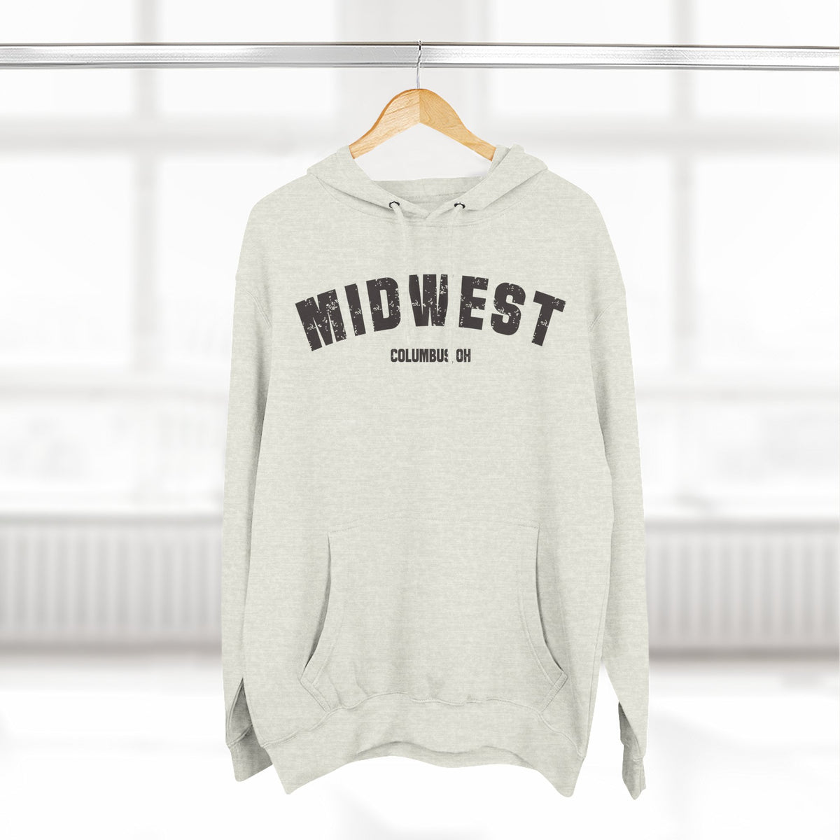 Oatmeal Heather personalized Midwest hoodie hanging on a wooden hanger