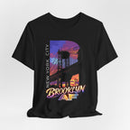 Black t-shirt, flat lay front view, with a bold B and a purple-orange Brooklyn Bridge sunset skyline graphic.
