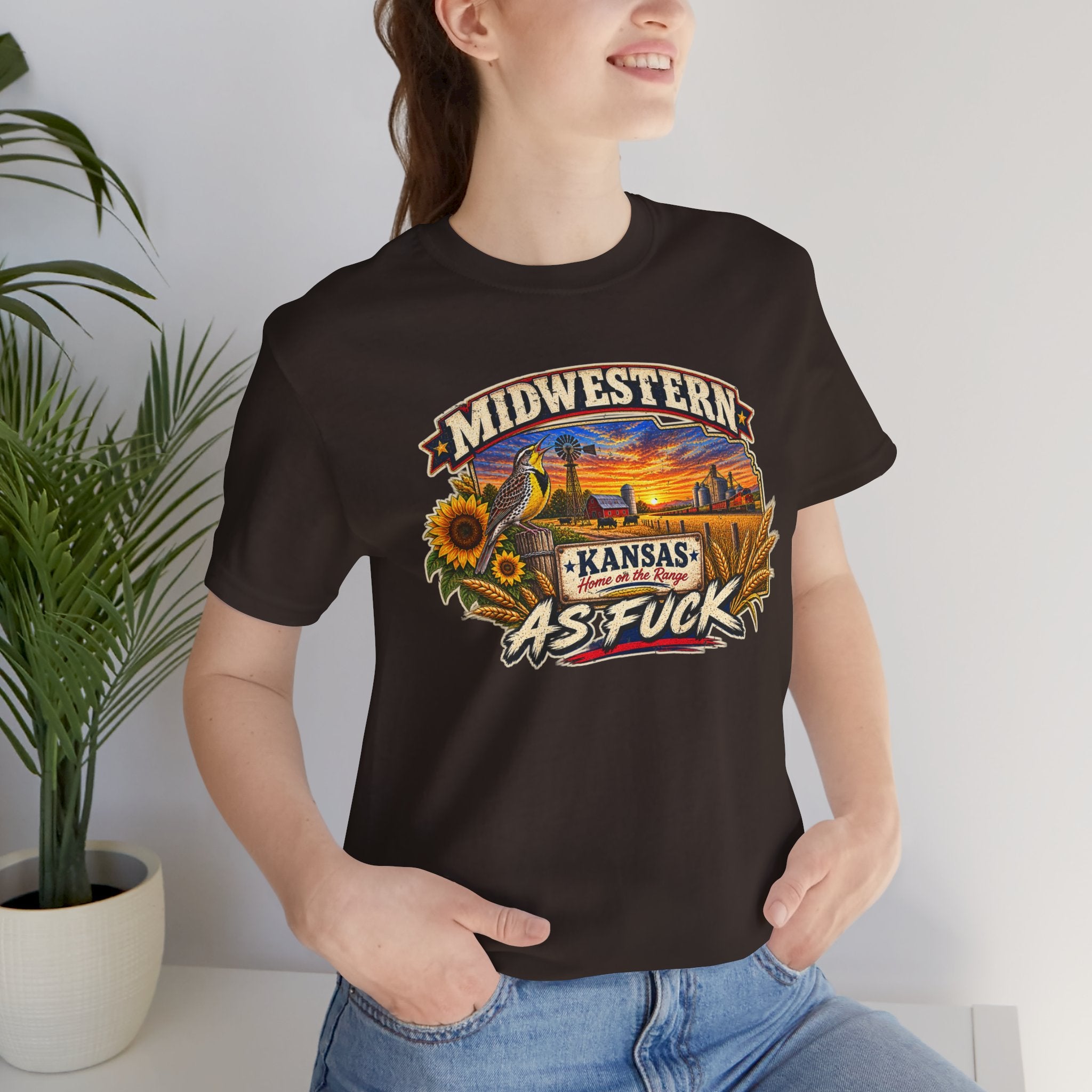 Woman in the brown Kansas As Fuck tee indoors, front graphic in close view