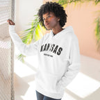 Woman leaning in a doorway wearing the white Kansas hoodie printed KANSAS over WICHITA EAST HIGH