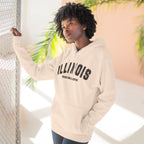 Woman by a sunlit fence in a Pale Pink custom Illinois hoodie, charcoal varsity ILLINOIS print