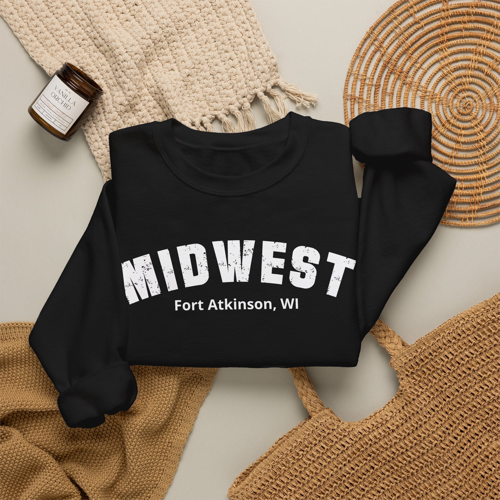 Black custom Midwest crewneck styled flat with a knit blanket and woven basket