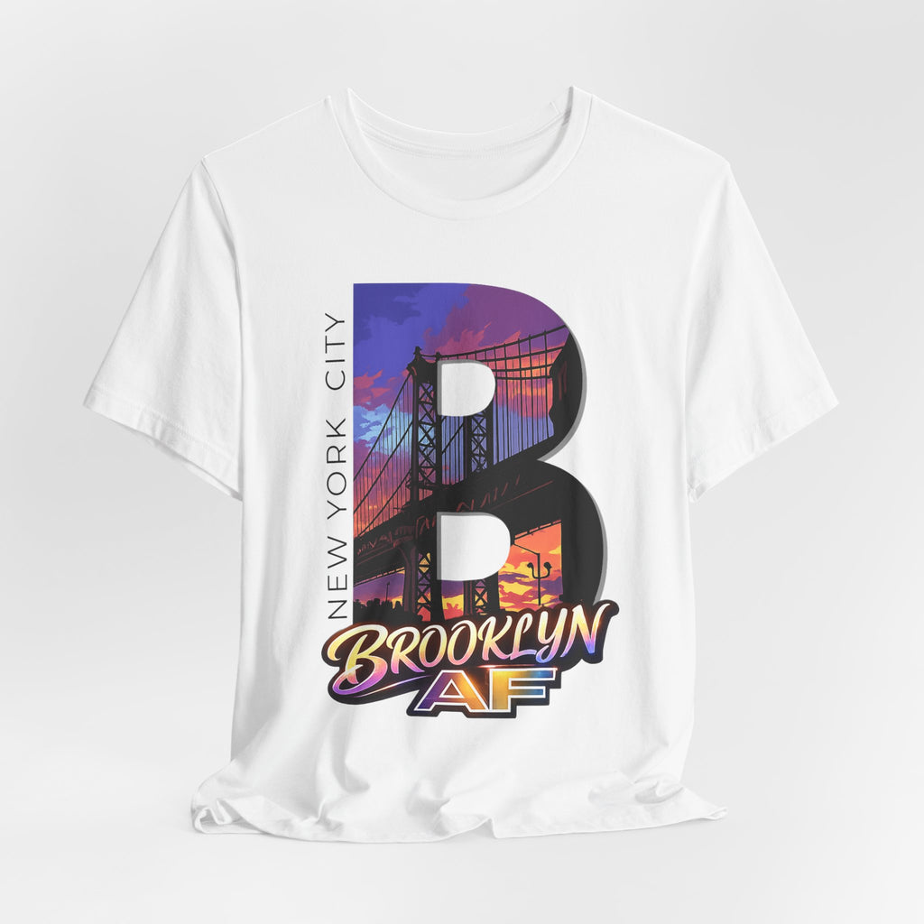 White tee, flat lay, front view, with the oversized "B" Brooklyn Bridge sunset skyline graphic and "Brooklyn AF" logo.