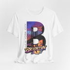 White tee, flat lay, front view, with the oversized "B" Brooklyn Bridge sunset skyline graphic and "Brooklyn AF" logo.