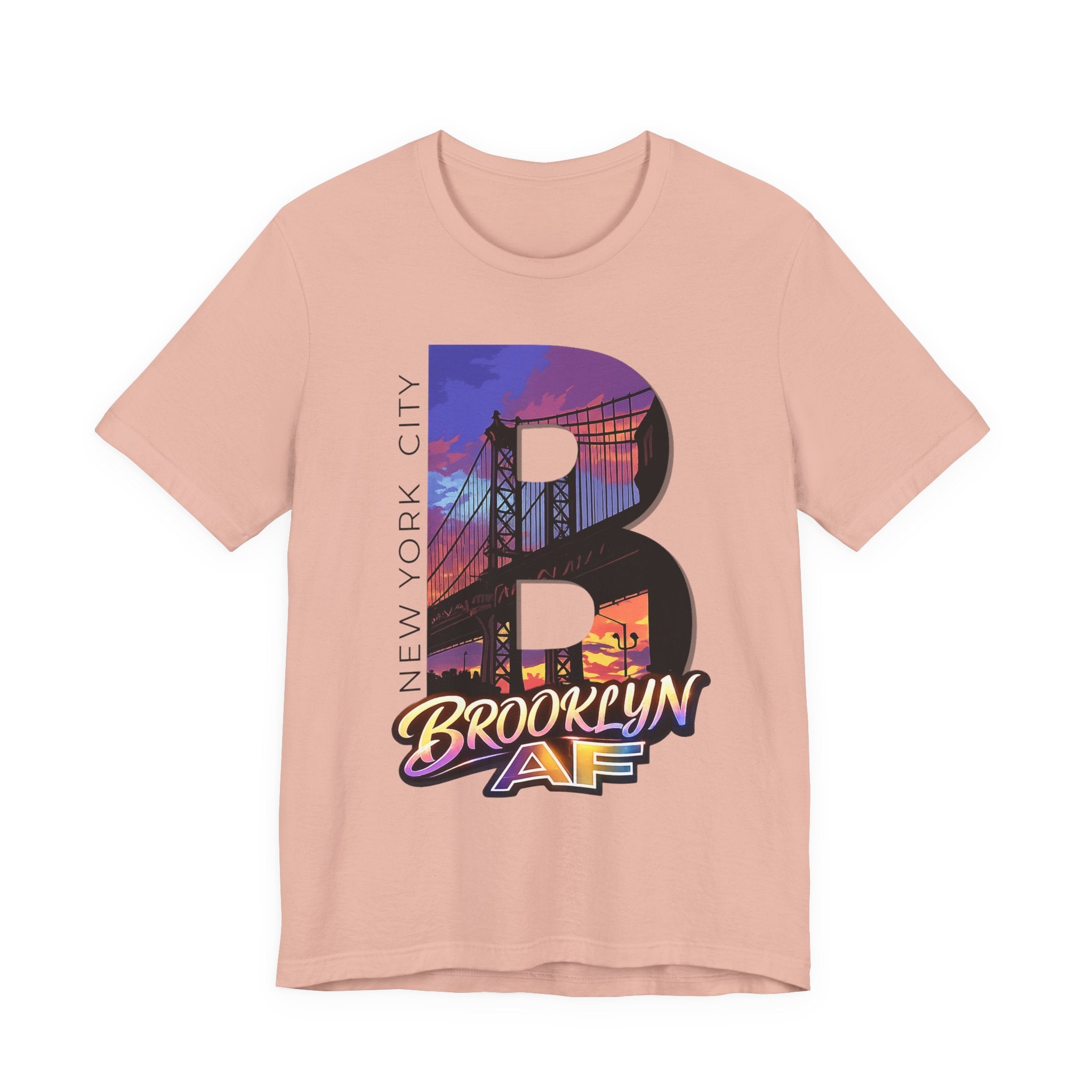 Heather Peach tee, flat lay, oversized "B" with purple-orange Brooklyn Bridge sunset skyline and "Brooklyn AF" script.