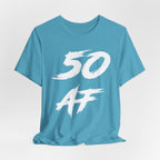 Close crop of the Heather Aqua tee laid flat, white 50 AF brush strokes in detail