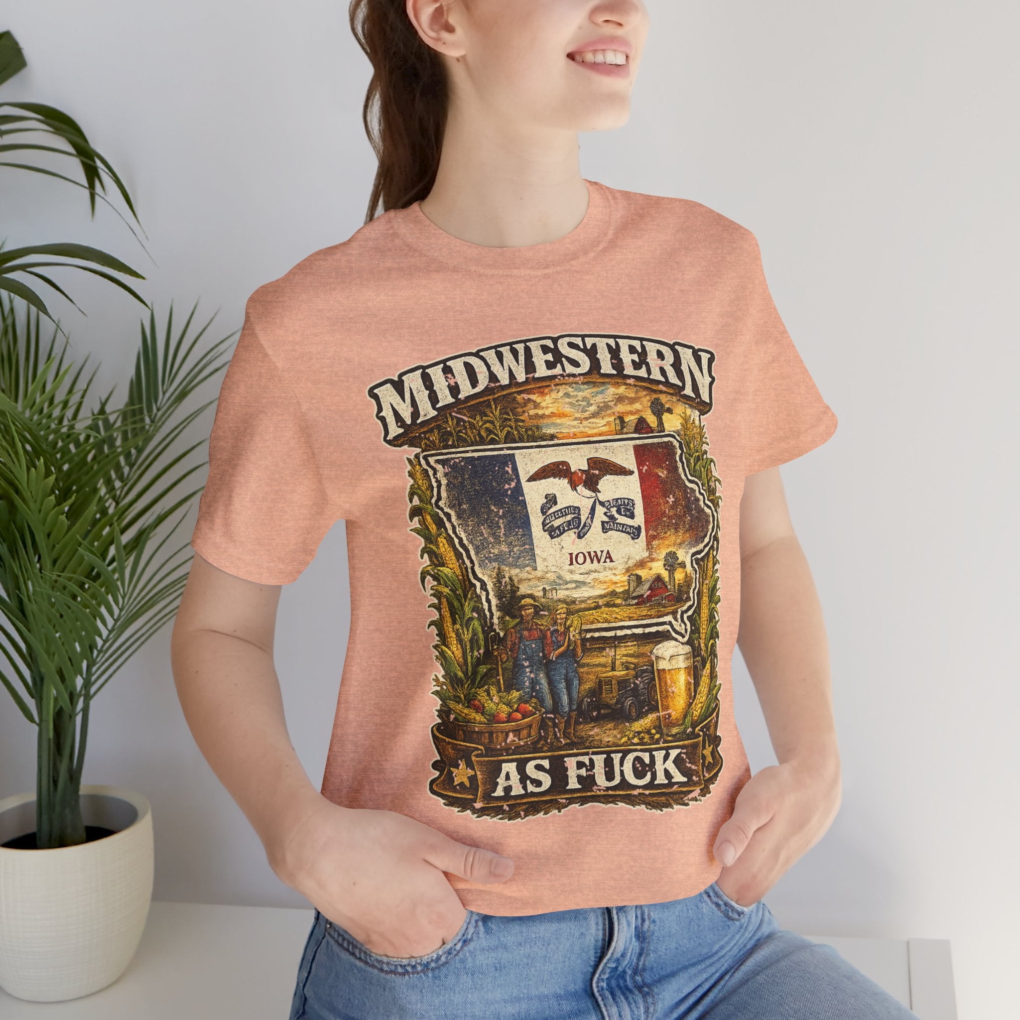 Midwestern As Fuck Iowa T-Shirt – product photo 2 featuring a distressed vintage design featuring the outline of Iowa overlaid with the Iowa state flag, surrounded by towering corn stalks, rolling farmland, a classic red barn, a windmill, a tractor, and an overflowing harvest basket