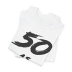 Folded white birthday tees stacked, the black 50 print showing on the top fold