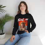 Woman seated beside a potted palm in the Black Feral AF crewneck, full graphic in view