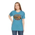 Woman wearing the heather aqua Nebraska As F**K tee against a plain backdrop