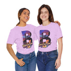 Light lilac t-shirts worn by two female models, front view, each with a bold "B" Brooklyn Bridge sunset skyline graphic.