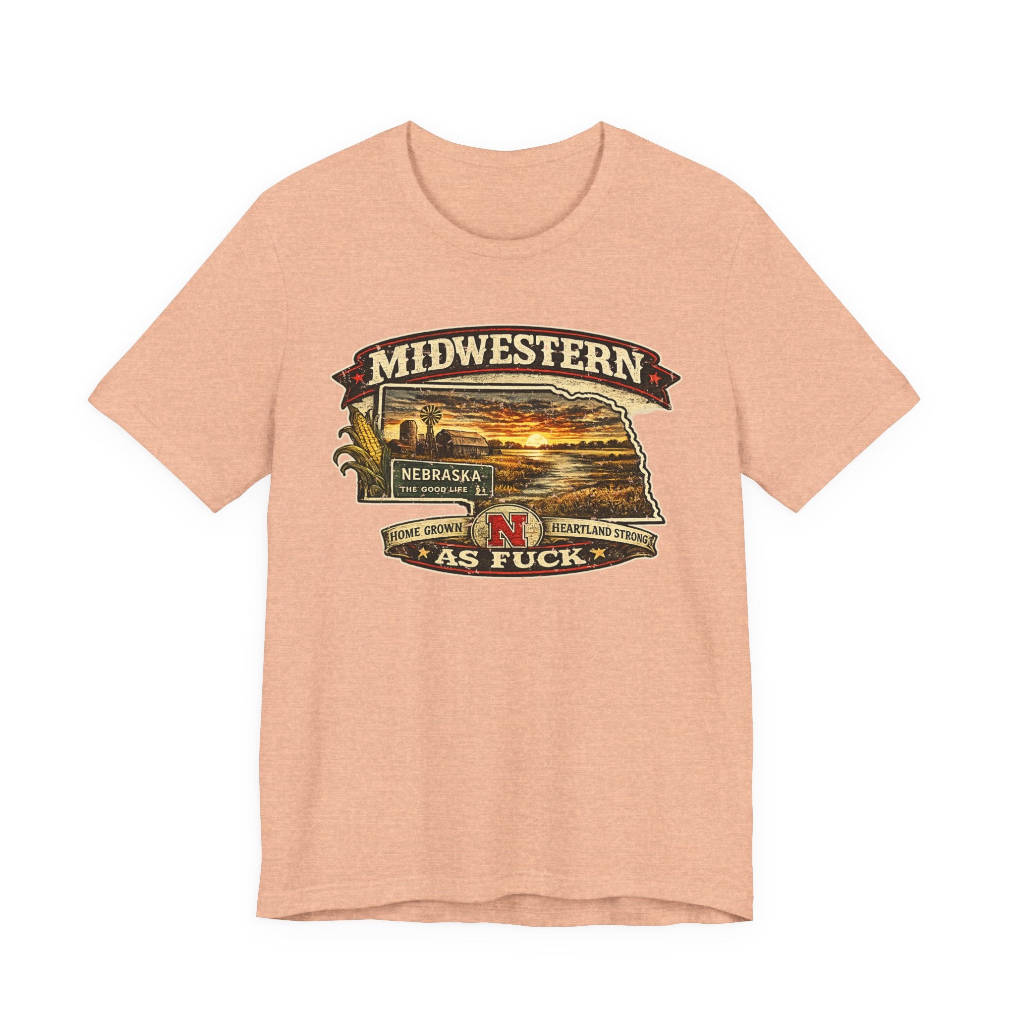 Heather peach Nebraska As Fuck tee laid flat, state-shaped sunset farm badge on the chest