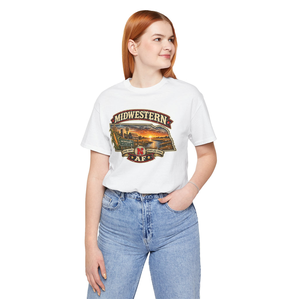 Woman wearing the white Nebraska tee with jeans, front print of the Nebraska sunset badge