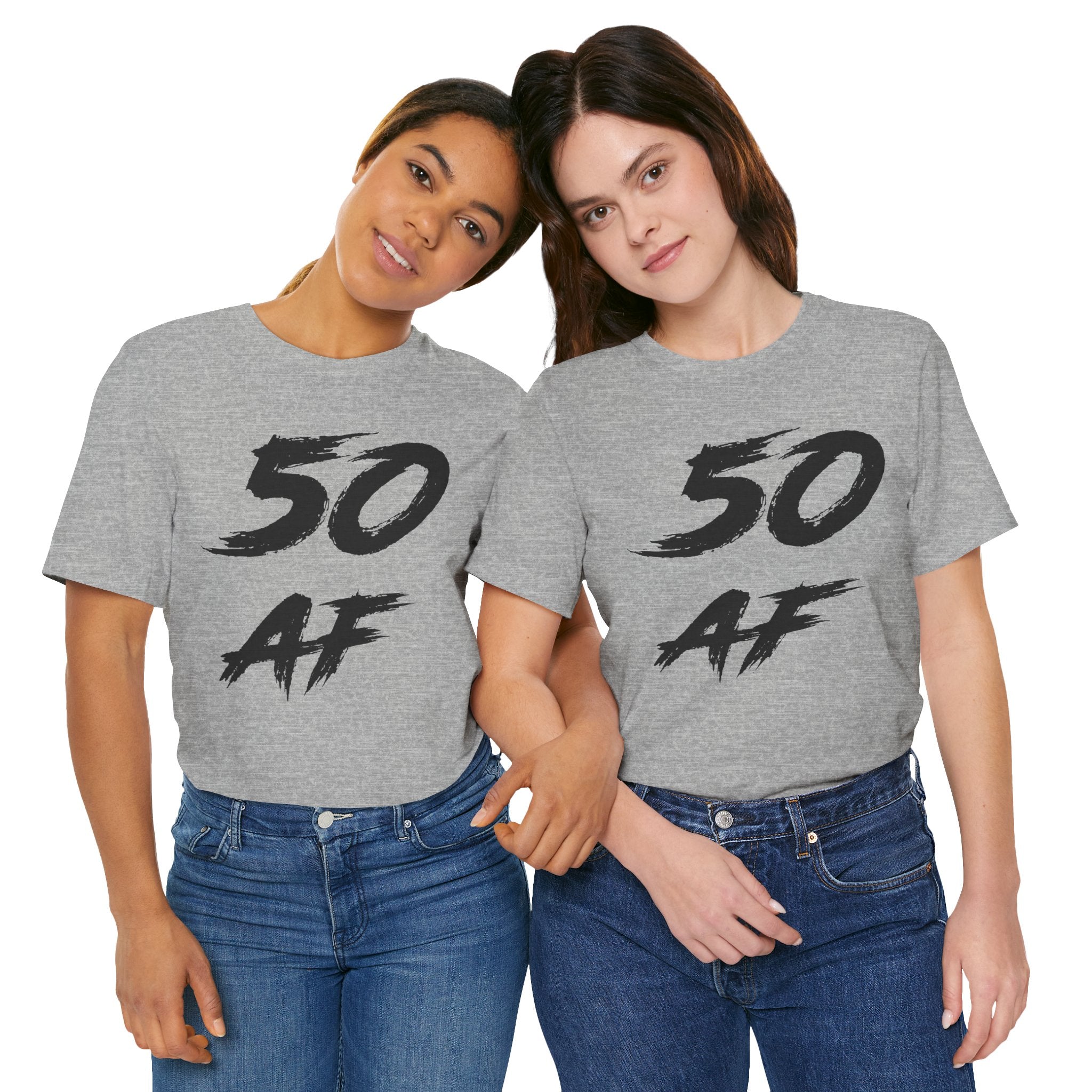 Two women side by side in Athletic Heather 50 AF tees with the black brush lettering