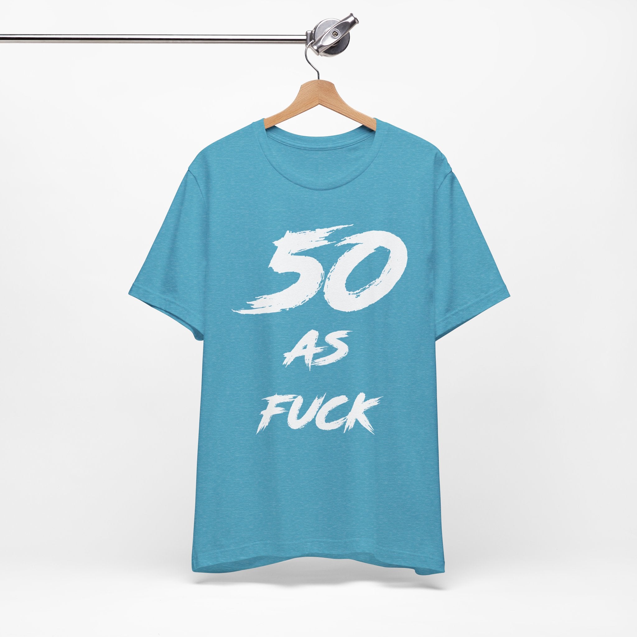 Heather Aqua birthday tee hanging on a hanger, white 50 AS FUCK graphic facing front