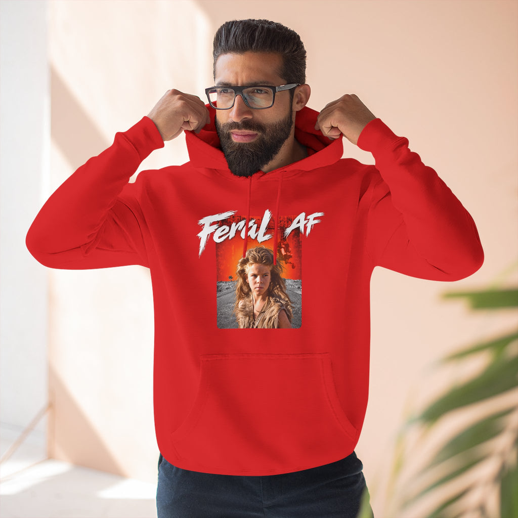 Man wearing the Red Feral AF hoodie, hands pulling the hood, feral kid graphic on show
