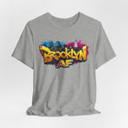 Athletic Heather t-shirt, front view flat lay, with graffiti-style Brooklyn AF lettering over a skyline splash.