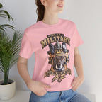 Woman wearing the Military K-9 T-shirt in Pink beside a potted plant